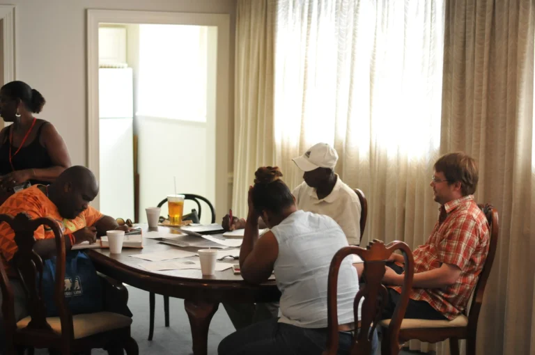 A Speak Up writing group around a table, writing